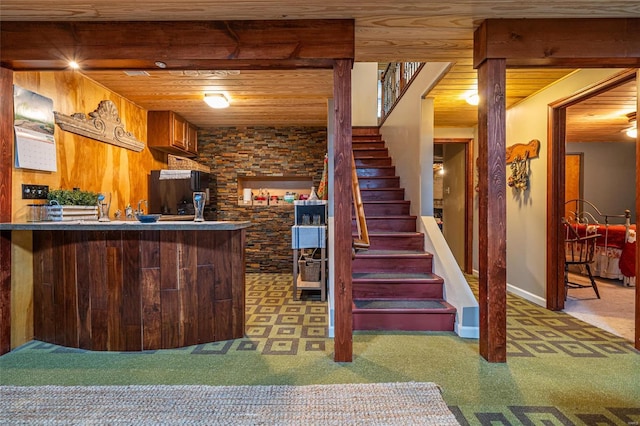 interior space featuring black refrigerator, wood ceiling, carpet flooring, and kitchen peninsula