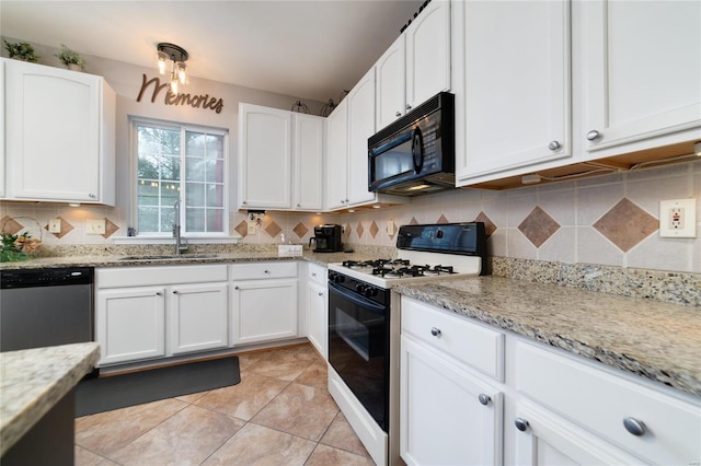 kitchen with sink, white cabinetry, light stone countertops, gas range oven, and stainless steel dishwasher