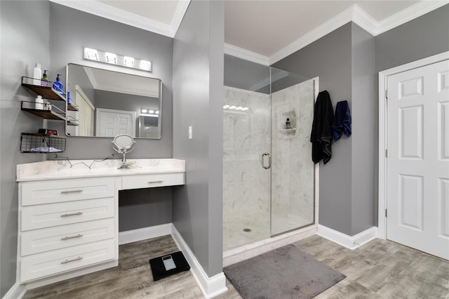 bathroom featuring vanity, crown molding, wood-type flooring, and a shower with door