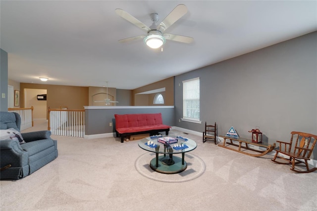 carpeted living room with ceiling fan