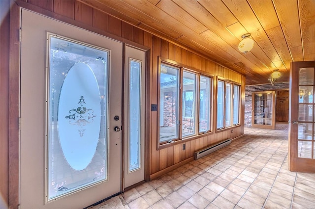 entryway featuring french doors, wood ceiling, baseboard heating, and wood walls