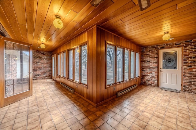 unfurnished sunroom featuring plenty of natural light, wooden ceiling, and baseboard heating