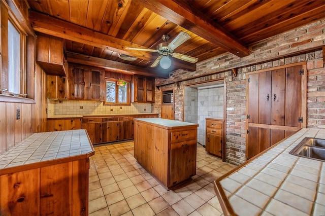 kitchen featuring wood ceiling, tile countertops, and a kitchen island