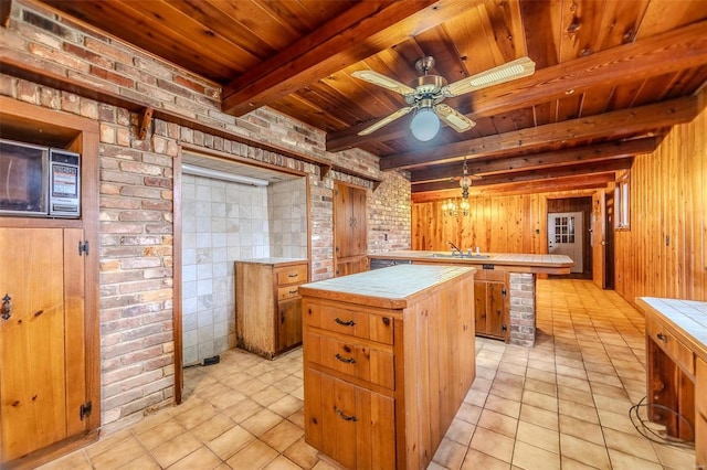 kitchen with a kitchen island, tile countertops, and wood ceiling