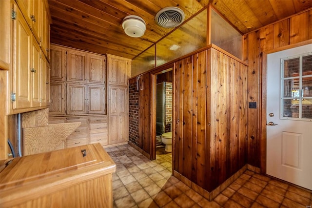 interior space featuring wood walls, butcher block counters, and wooden ceiling