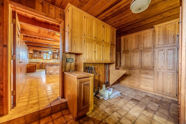 kitchen featuring light tile patterned floors and wood ceiling