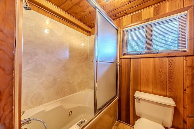 bathroom featuring wood ceiling, toilet, shower / bath combination with glass door, and wood walls