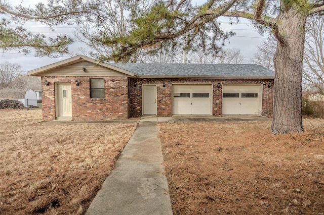 ranch-style house featuring a garage and a front lawn