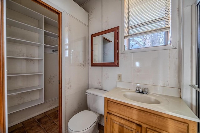 bathroom featuring vanity, tile patterned flooring, and toilet