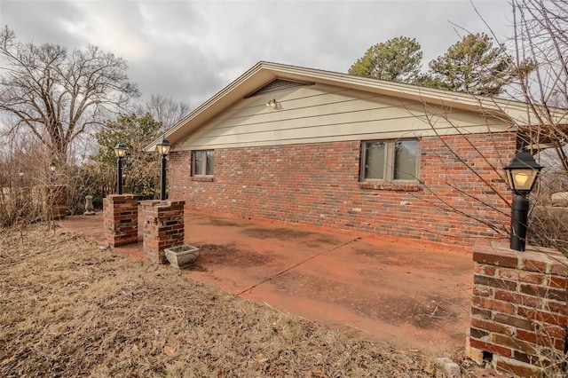 view of side of home with a patio