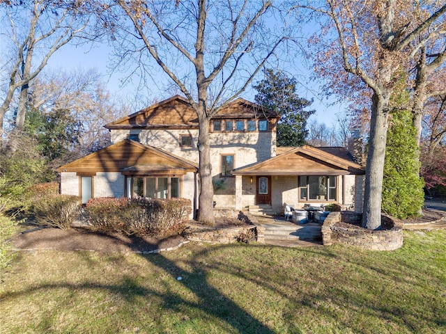 rear view of house with a patio area and a lawn