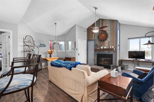 living room featuring a healthy amount of sunlight, a textured ceiling, a fireplace, and dark hardwood / wood-style flooring