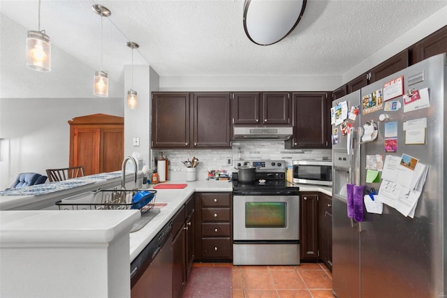 kitchen featuring stainless steel appliances, tasteful backsplash, hanging light fixtures, and kitchen peninsula