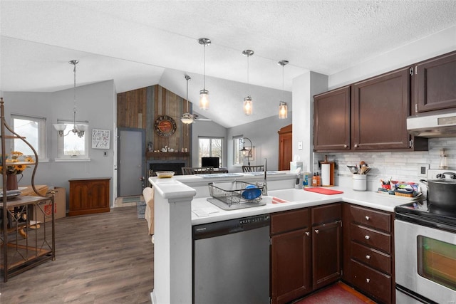 kitchen featuring hanging light fixtures, appliances with stainless steel finishes, dark hardwood / wood-style flooring, kitchen peninsula, and ceiling fan