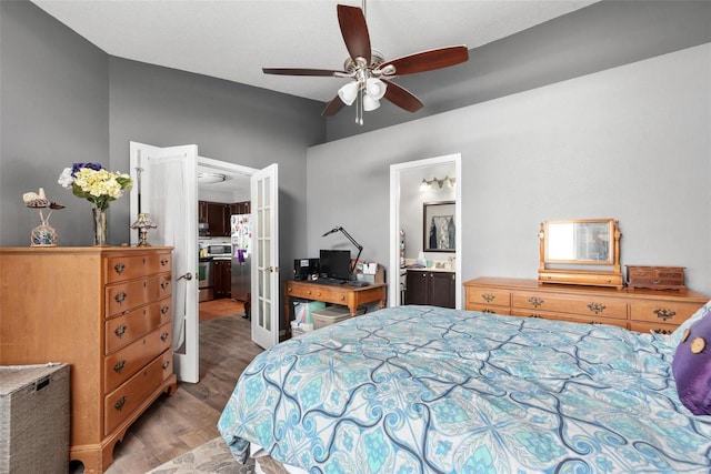 bedroom with ensuite bath, light hardwood / wood-style flooring, french doors, and ceiling fan