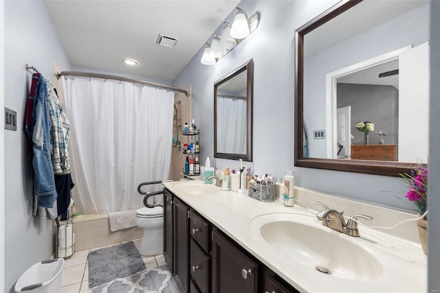 full bathroom featuring shower / bath combination with curtain, vanity, toilet, tile patterned floors, and a textured ceiling