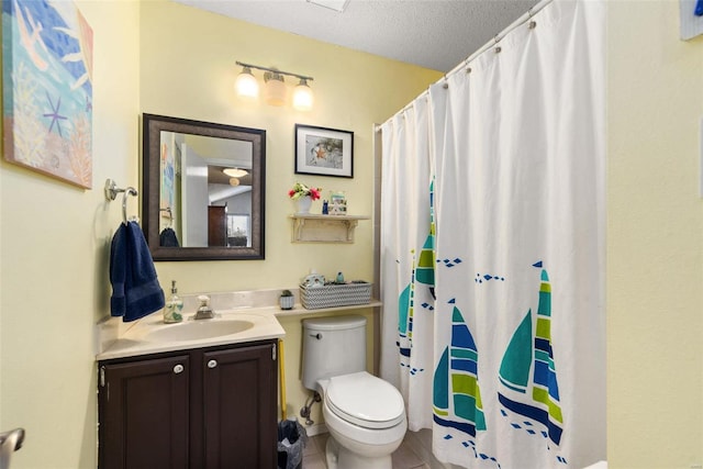 bathroom with vanity, toilet, curtained shower, and a textured ceiling