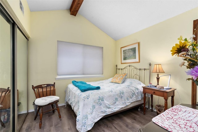 bedroom with dark hardwood / wood-style floors, lofted ceiling with beams, and a closet