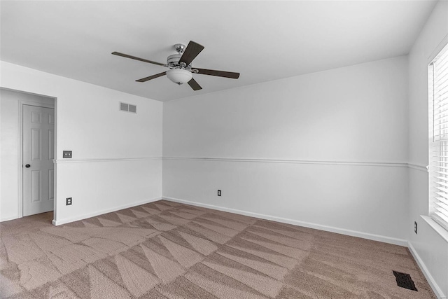 spare room with ceiling fan and carpet flooring