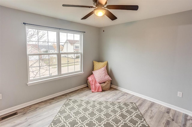 living area featuring ceiling fan and light hardwood / wood-style floors