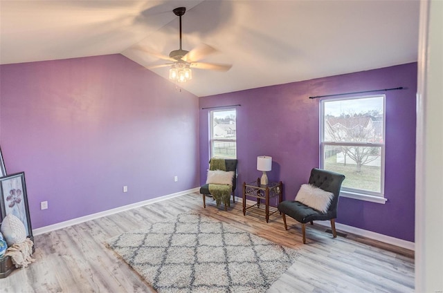 sitting room with lofted ceiling, ceiling fan, and light hardwood / wood-style flooring