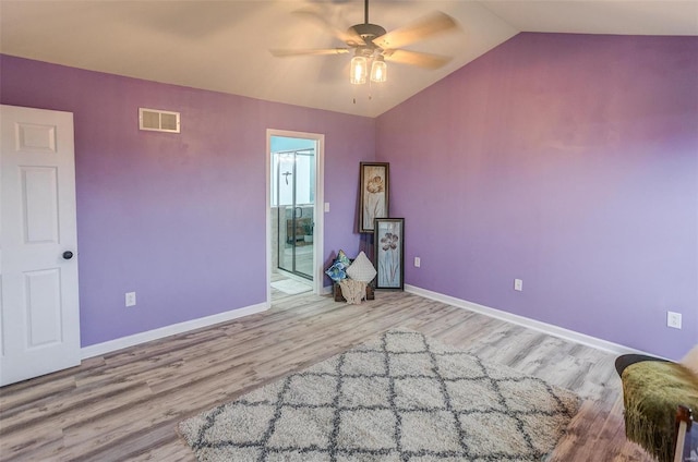 interior space with vaulted ceiling, ceiling fan, and light hardwood / wood-style flooring