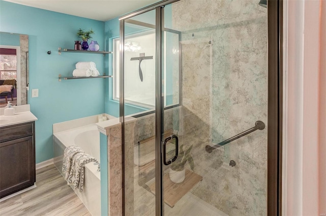 bathroom featuring vanity, shower with separate bathtub, and hardwood / wood-style floors