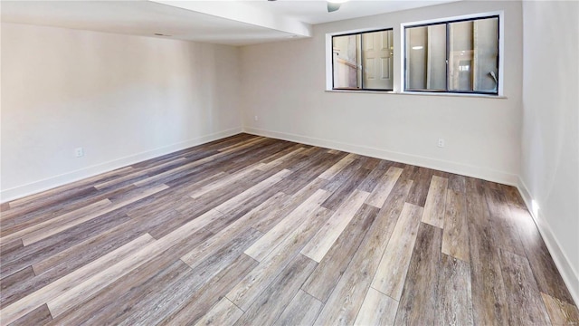 unfurnished room with hardwood / wood-style flooring