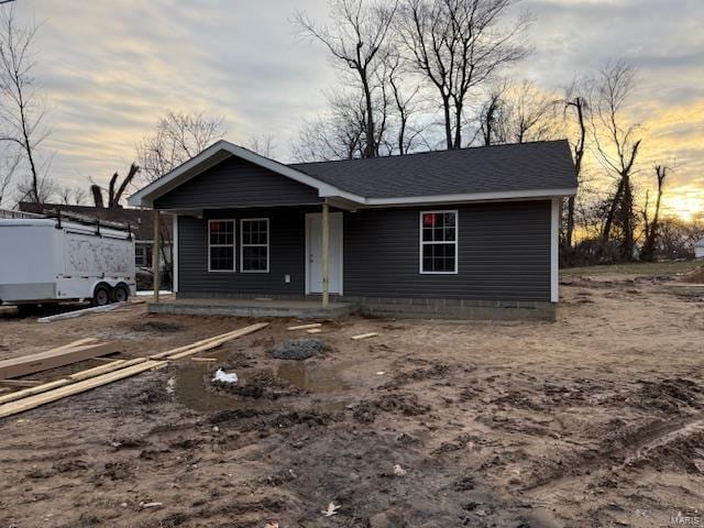 view of front of home with a porch and a shingled roof