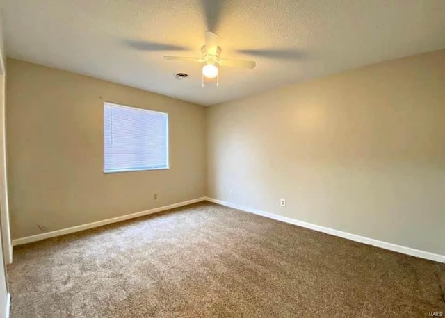 carpeted empty room featuring a textured ceiling and ceiling fan