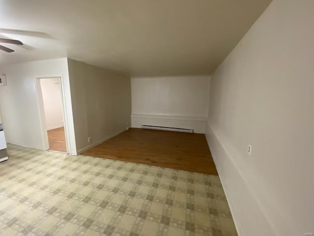 bonus room with ceiling fan, light wood-type flooring, and baseboard heating