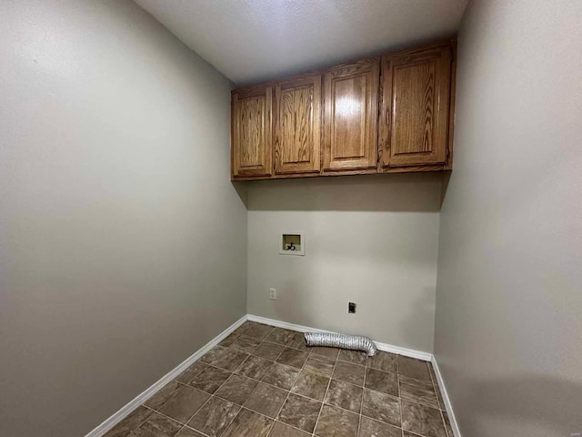 washroom with hookup for a washing machine, cabinets, and hookup for an electric dryer