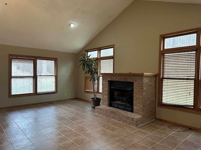 unfurnished living room featuring tile patterned flooring, vaulted ceiling, and a fireplace