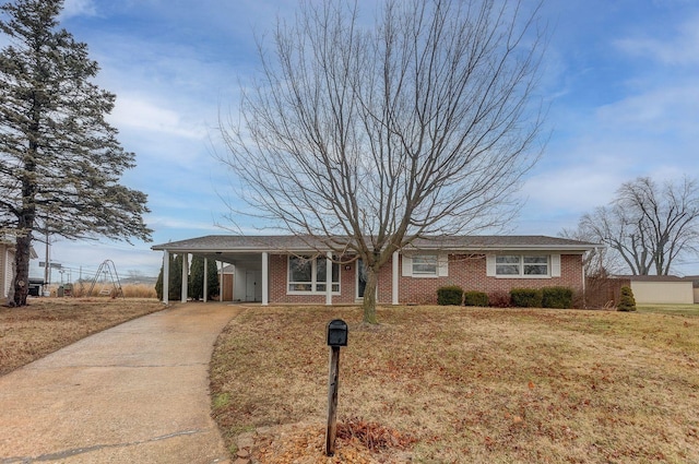 ranch-style house with a front yard and a carport