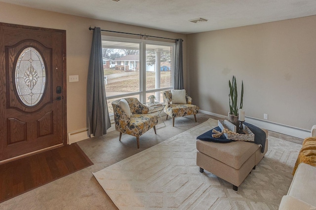 entrance foyer featuring a baseboard heating unit and light carpet