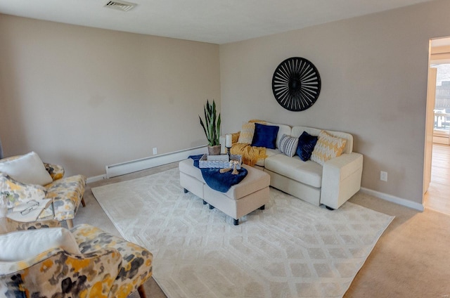 living room featuring a baseboard heating unit and light carpet