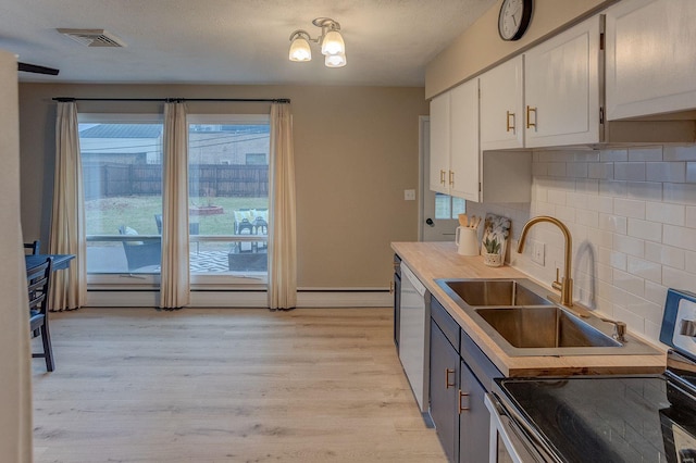 kitchen featuring sink, white cabinetry, dishwasher, light hardwood / wood-style floors, and backsplash