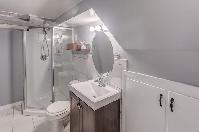 bathroom featuring vanity, toilet, and a shower with shower door