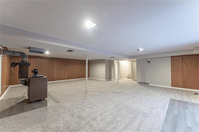 basement with wooden walls and carpet