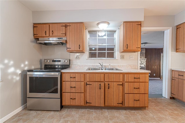 kitchen featuring sink, decorative backsplash, and stainless steel electric range