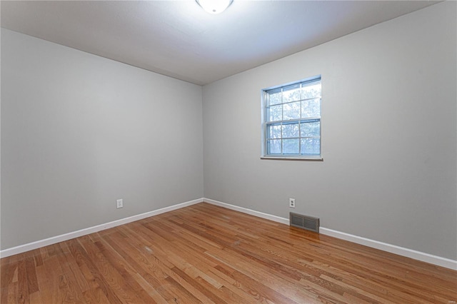 spare room with light hardwood / wood-style flooring