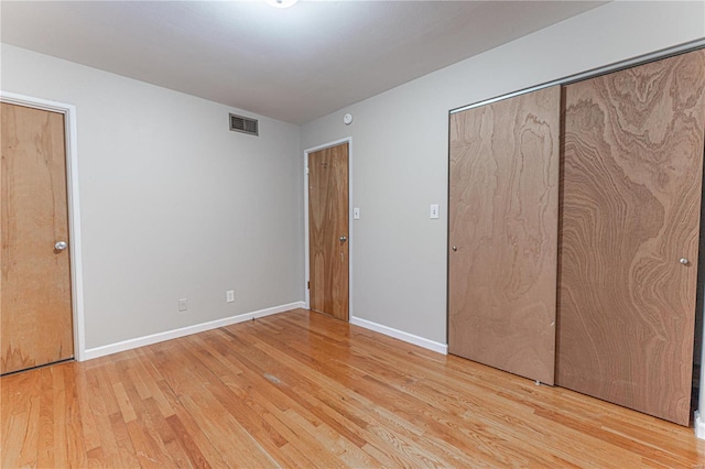 unfurnished bedroom with light wood-type flooring