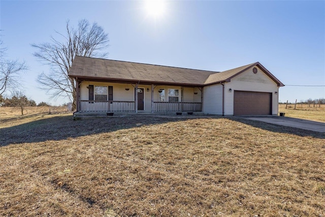 ranch-style house with a porch, a garage, and a front lawn