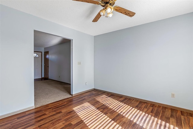 empty room featuring wood-type flooring, ceiling fan, and a textured ceiling