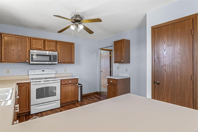 kitchen featuring ceiling fan, electric range, dark hardwood / wood-style floors, and a textured ceiling