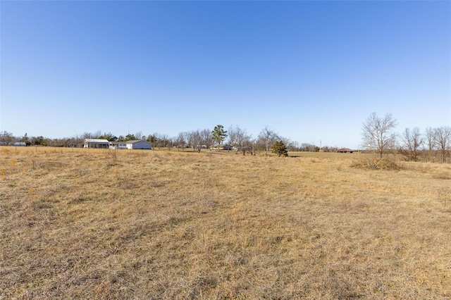 view of yard with a rural view