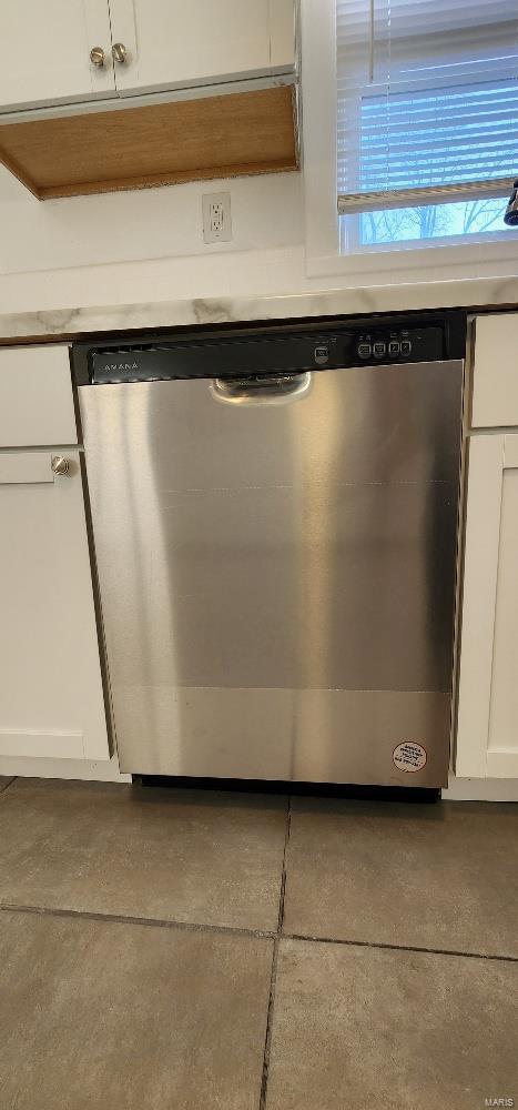 interior details featuring stainless steel dishwasher and white cabinets