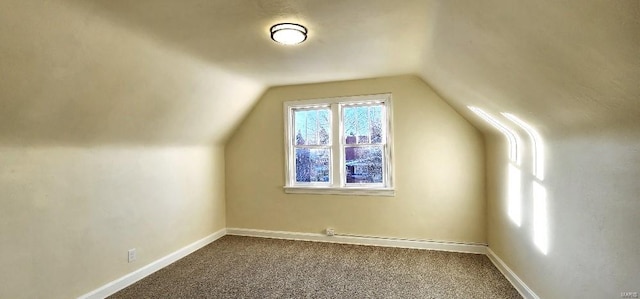 bonus room featuring vaulted ceiling and carpet flooring