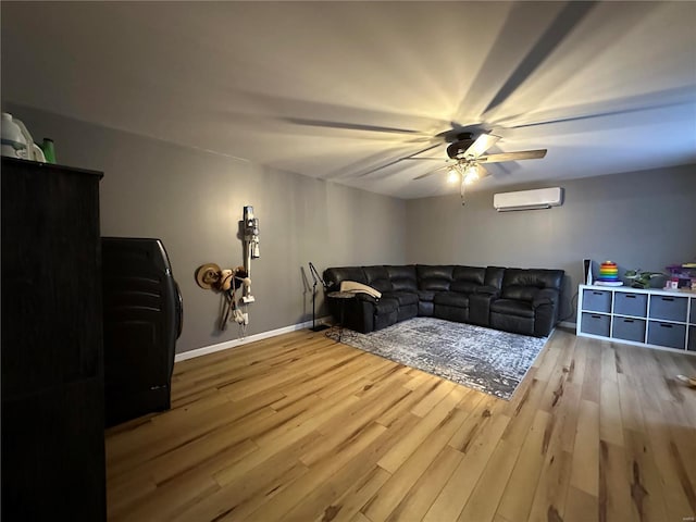 living area with baseboards, a ceiling fan, wood finished floors, and a wall mounted air conditioner