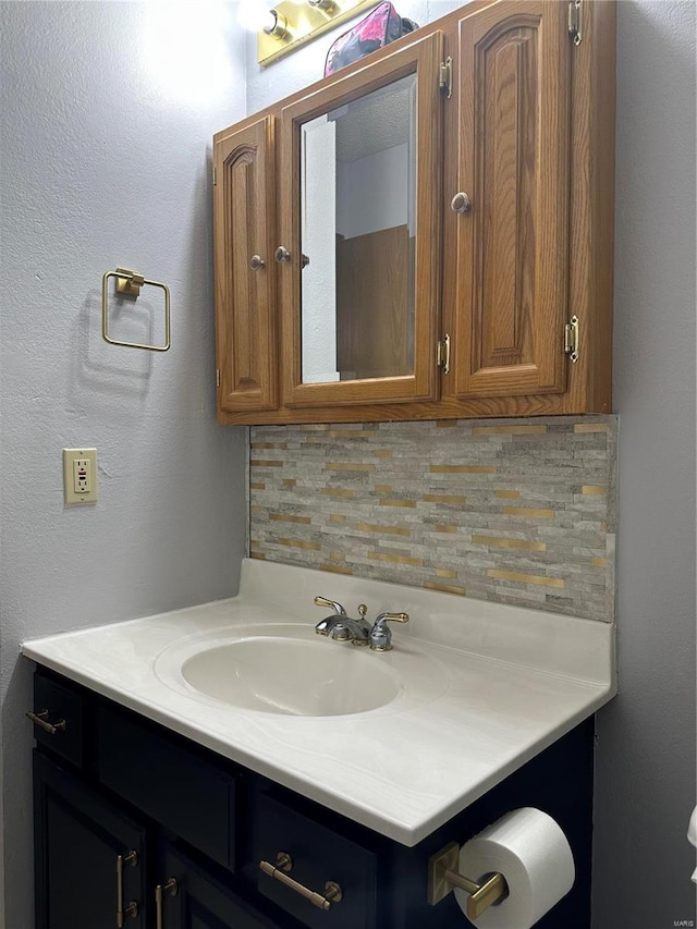 bathroom with decorative backsplash and vanity